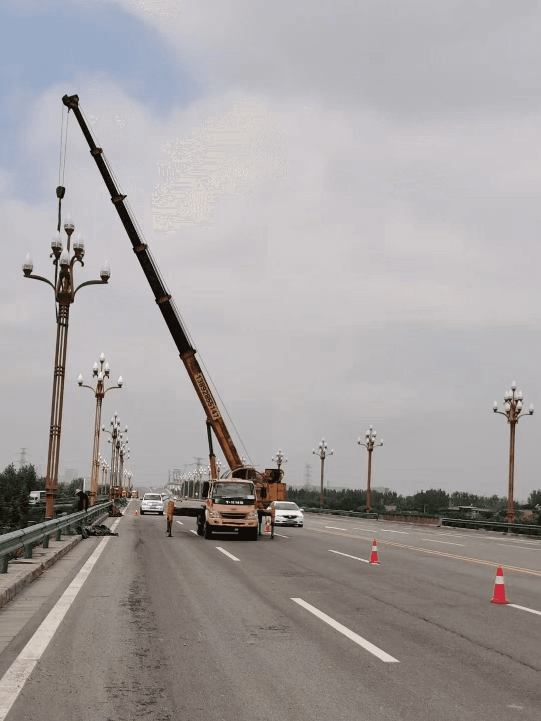 Decorative multi-arm street lamps installed on a highway bridge