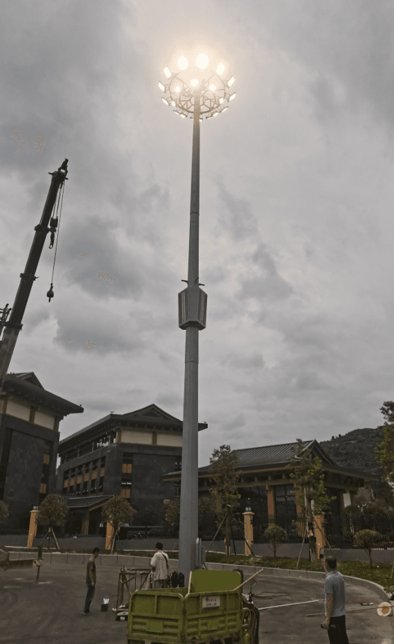 High-mast LED floodlight tower at a Chinese traditional-style resort complex
